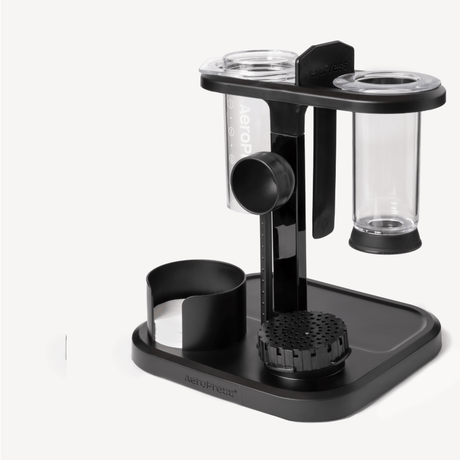 Black and clear coffee brewing device on a white background