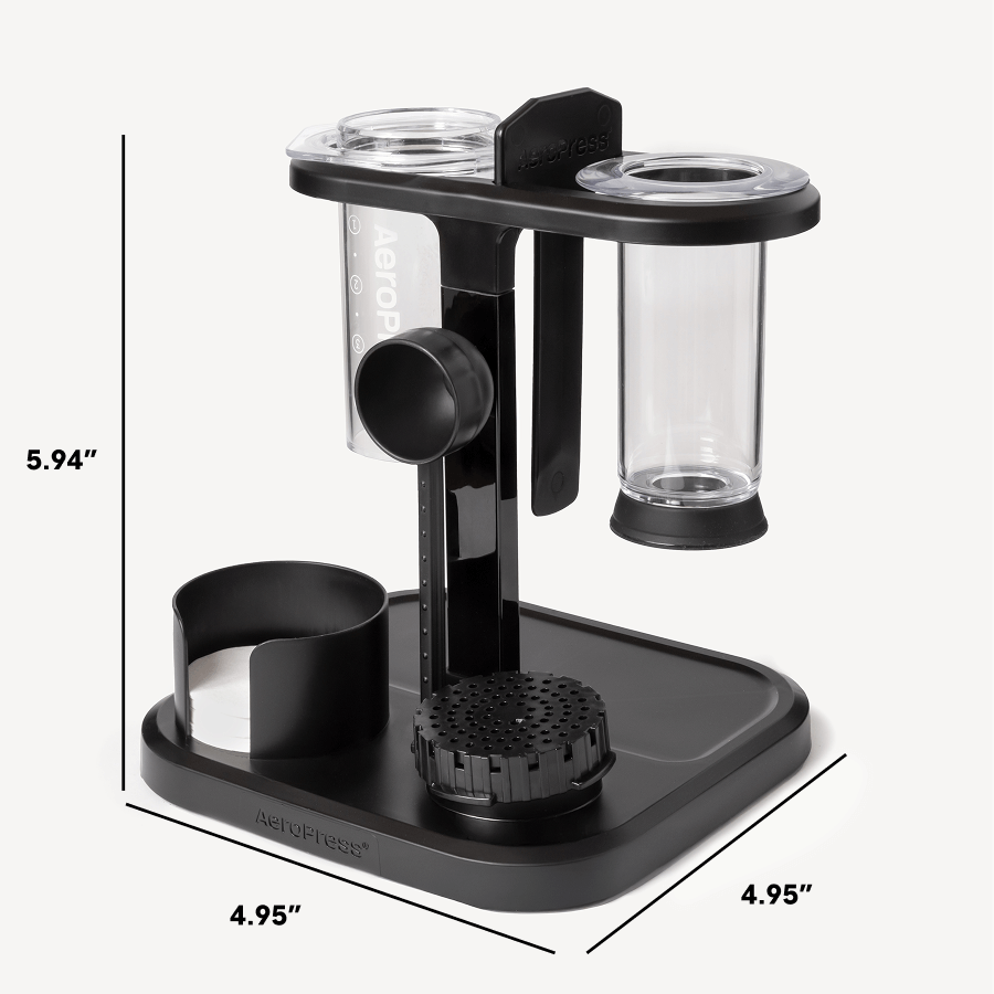Black and clear coffee brewing device with measurements on a white background