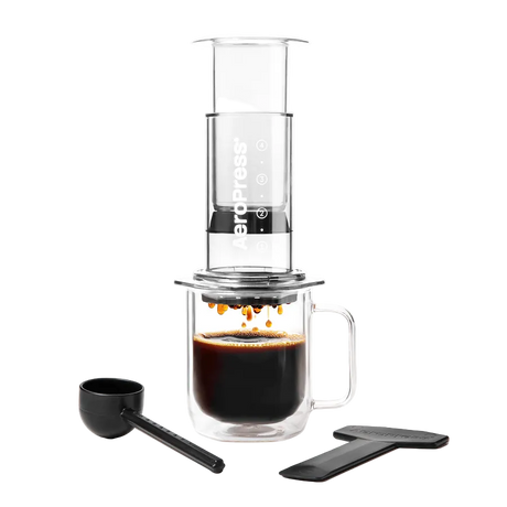 Coffee brewing device with a glass mug and scoop on a white background #color_clear