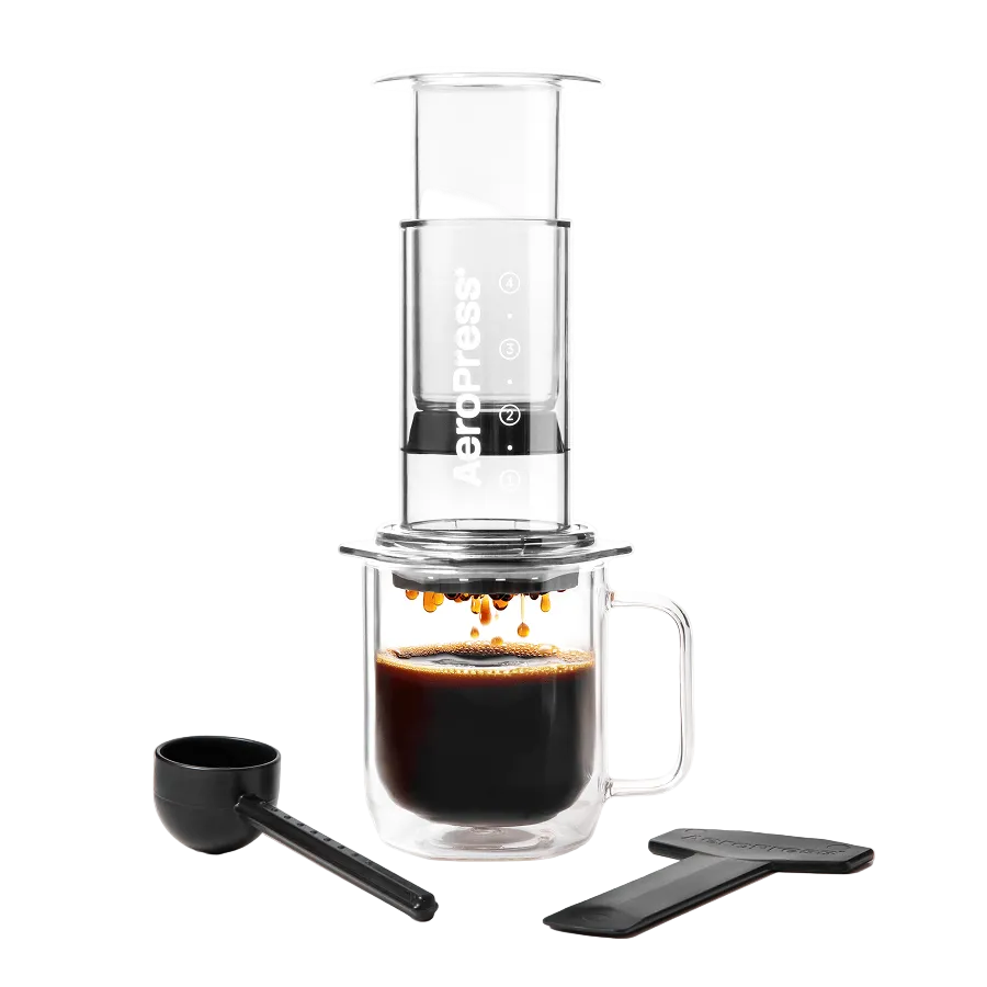 Coffee brewing device with a glass mug and scoop on a white background #color_clear