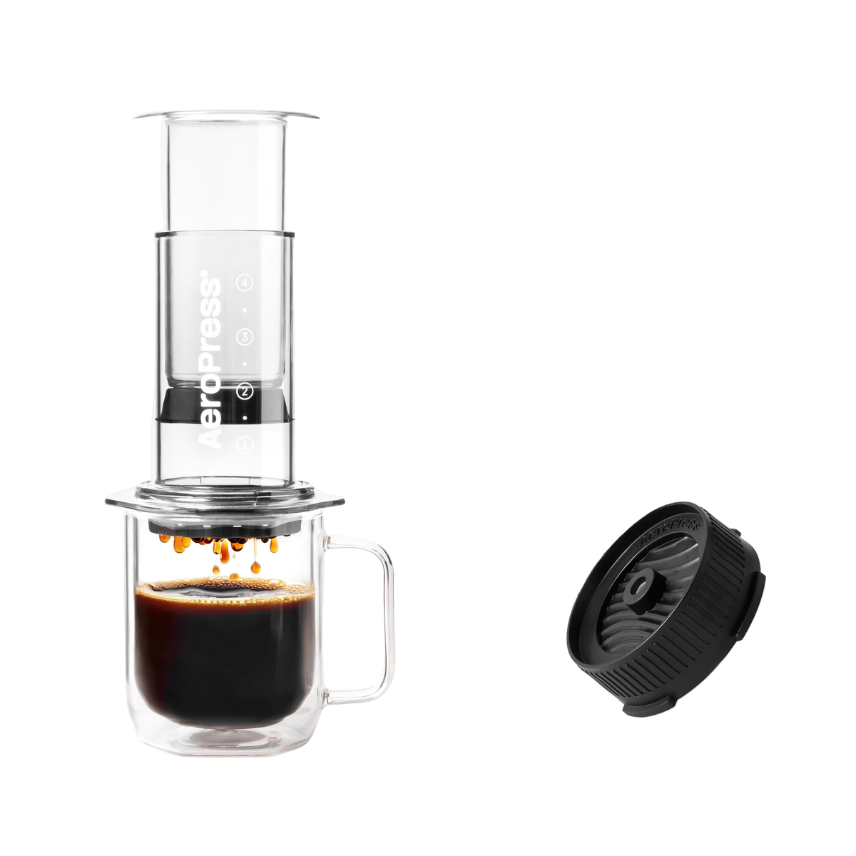 Aeropress coffee maker with a cup of coffee and a black filter on a white background Clear Pink #color_clear