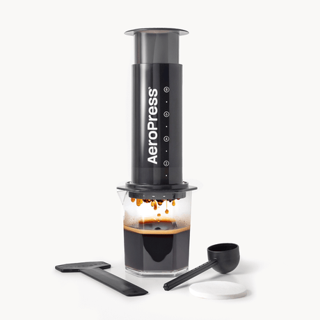 AeroPress XL coffee maker with a carafe of brewed coffee on a white background