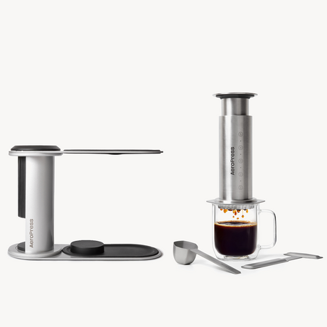 Aeropress coffee maker with a glass of coffee on a white background #color_silver