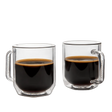 Two clear glass mugs filled with black coffee on a white background
