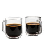 Two clear glass mugs filled with black coffee on a white background