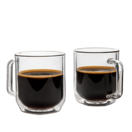 Two clear glass mugs filled with black coffee on a white background