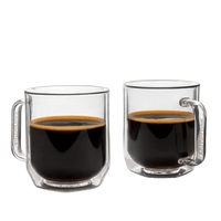 Two clear glass mugs filled with black coffee on a white background
