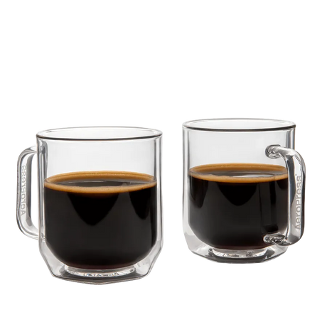 Two clear glass mugs filled with black coffee on a white background