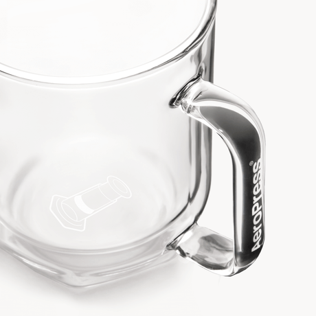 Clear glass AeroPress Mug with handle on a white background