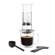 Coffee brewing device with a glass mug and scoop on a white background #color_clear