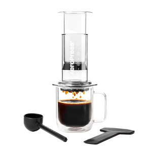 Coffee brewing device with a glass mug and scoop on a white background #color_clear