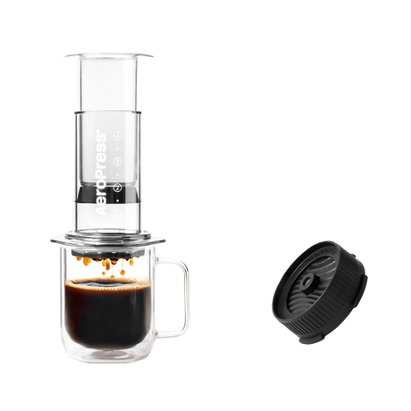 Aeropress coffee maker with a cup of coffee and a black filter on a white background Clear Pink #color_clear