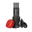 AeroPress Go coffee maker with red lid and black scoop on a white background