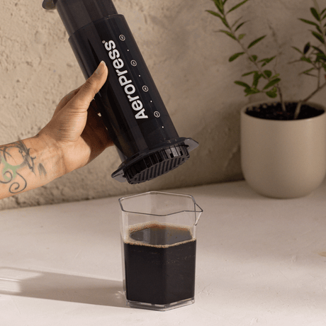 AeroPress XL coffee maker with coffee in a carafe