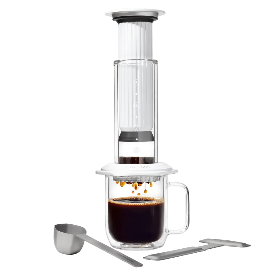AeroPress Premium coffee maker with glass mug and scoop on a white background #color_white