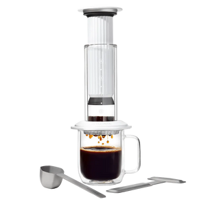 AeroPress Premium coffee maker with glass mug and scoop on a white background #color_white