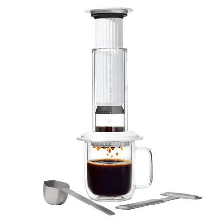 AeroPress Premium coffee maker with glass mug and scoop on a white background #color_white