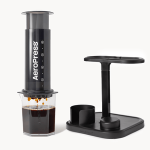 Aeropress coffee maker with a stand on a white background