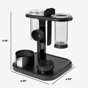 Black and clear coffee brewing device with measurements on a white background